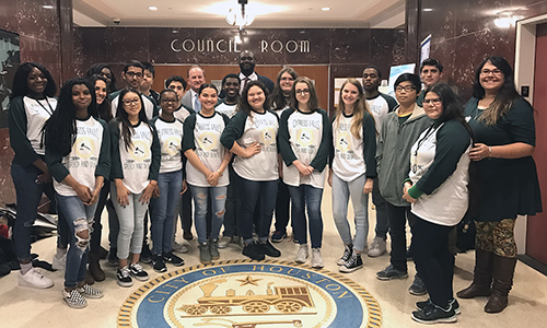 Houston City Councilmen Jerry Davis (center back row) and Dave Martin (back row in gray suit) pose with Cypress Falls High School Debate I students and their teacher Miranda Fairman (right) during a trip to City Hall on Jan. 24. The class recently visited Houston City Hall and attended a City Council meeting to observe government and policymaking in real life. Boykins served as the class’ guide.