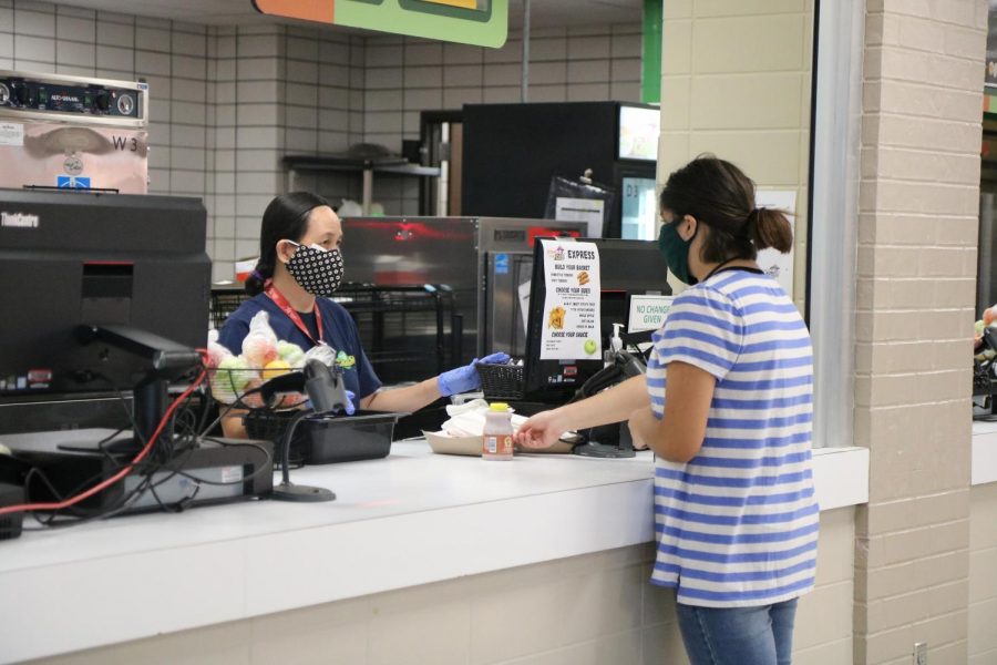 Students purchase and eat their lunches while socially distant.