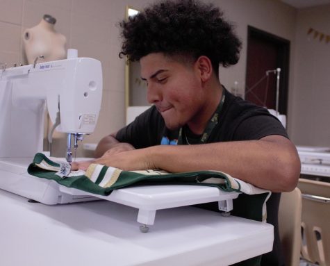 Vice President sewing a cheer shirt